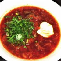 Borsh · Beet, beef, and vegetables. Served with sour cream and fresh herbs in and pita bread on the ...