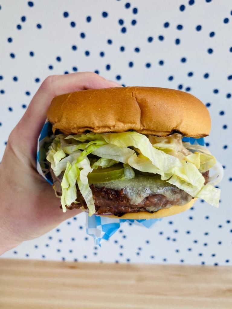Veggie Burger · Beyond burger patty, Tillamook cheddar, iceberg lettuce, red onion, Holler pickles, secret sauce 