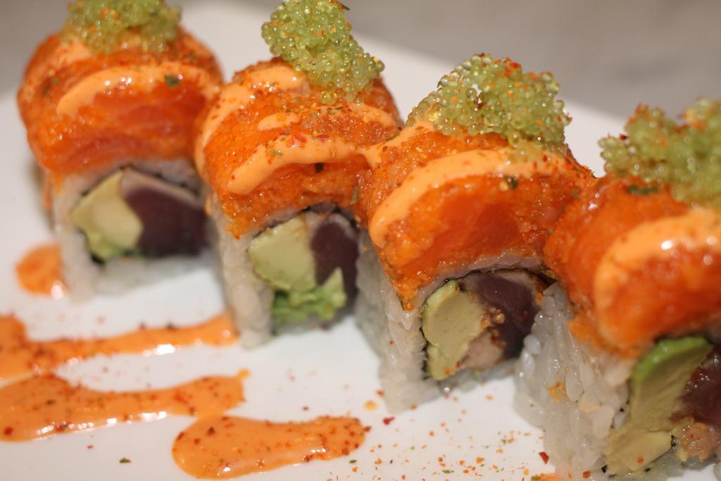 Spicy Girl Roll · Pepper tuna, avocado inside, spicy crunchy salmon outside with wasabi tobiko in spicy mayo sauce.