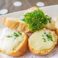 Garlic Bread · Oven baked garlic bread covered in mozzarella and parmigiano cheese served with marinara sau...
