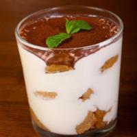 Tiramisu · Coffee infused dessert with creamy, sweet mascarpone and topped with cocoa powder.