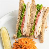 Turkey Eastsider Sandwich · We season and roast a whole turkey breast, slice it thick and layer with lettuce, tomato, Sw...