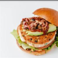 Salmon Burger · House-made with fresh salmon, lemon zest jalapeno peppers, on brioche roll with lettuce, tom...