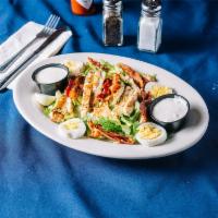 Cobb Salad · A healthy pile of romaine lettuce with grilled chicken, crispy bacon, hardboiled egg and ble...