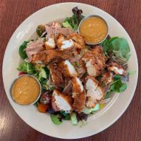 Cobb Salad · Crispy chicken, country ham, cucumbers, cherry tomatoes, herb croutons on a bed of fresh loc...