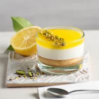 Coppa Lemon Vanilla pistachio · Sponge cake soaked in lemon juice followed by vanilla flavored cream, topped with lemon sauc...