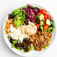Greek Chicken Salad · Mixed Greens with tomatoes, Feta, tzatziki, almonds, butter beans, stuffed grape leaves,& Pu...