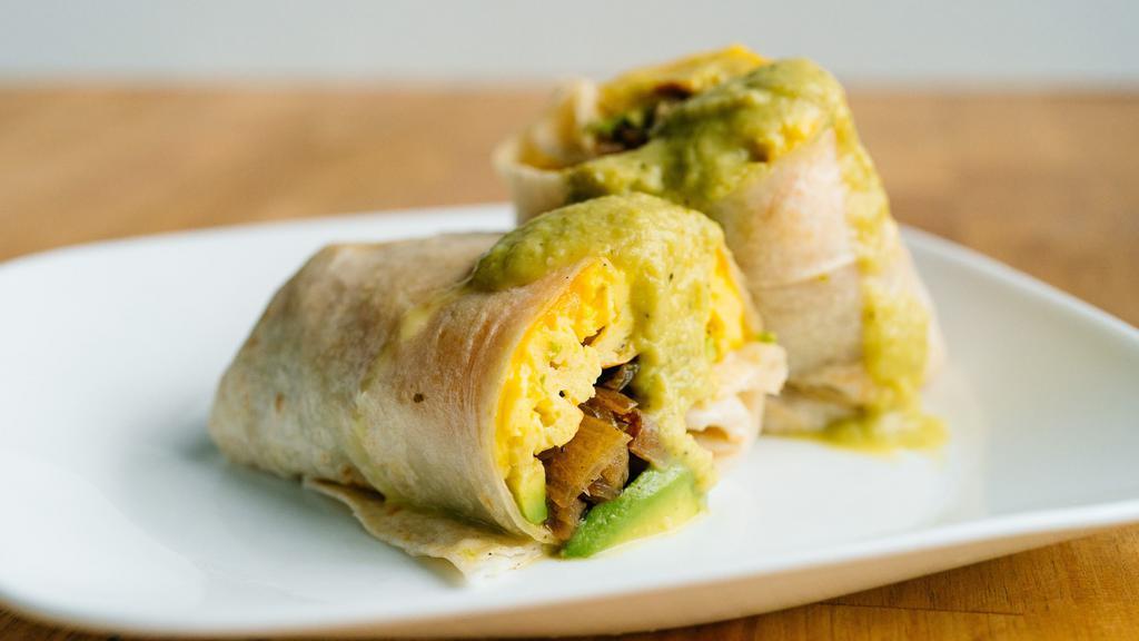 Veggie Breakfast Burrito · 3 cheesy scrambled eggs, choice of potatoes, avocado, crispy spinach and fresh sliced tomato. Comes with a side of spicy mayo or house made salsa.