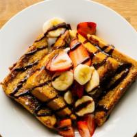 Nutella Strawberry Banana French Toast · Our classic french toast garnished with fresh strawberries, bananas, and creamy Nutella. Ser...