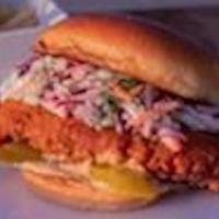 Buttermilk Fried Chicken Sandwich · Buttermilk fried chicken served on a brioche bun with creamy coleslaw, dill pickles and buff...