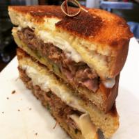 El Jeffe Cubano · Shredded mojo pork, shaved black forest ham, Swiss cheese, yellow mustard and pickles, on gr...