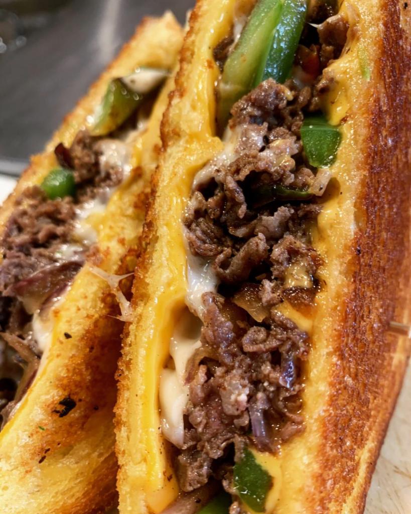 Philly Steak Melt · Thinly shaved beef, American and provolone cheeses, grilled onions and peppers and our house seasoning blend, on thick cut brioche.