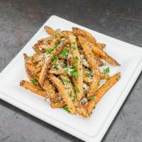 Truffle Shuffle Fries · Crispy hand-cut french fries tossed in black truffle oil and blended with cold-smoked Parmig...