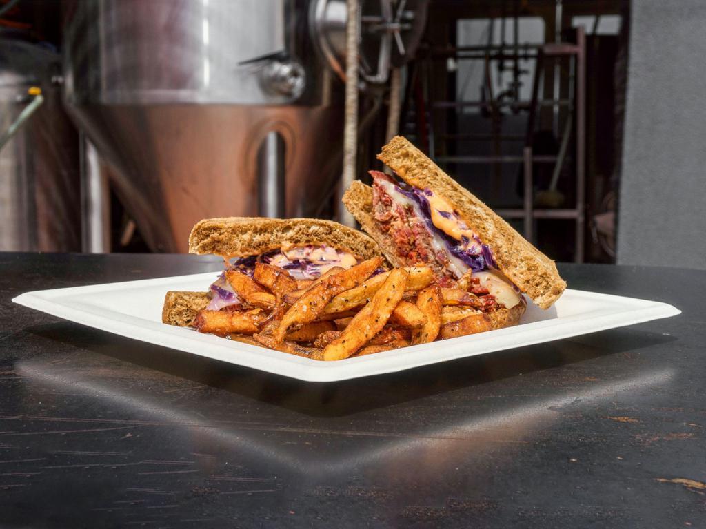 The Rick Ruben Sandwich · Slow smoked house-cured pastrami with Swiss cheese, DB house red cabbage sauerkraut, and a Russian Imperial dressing.