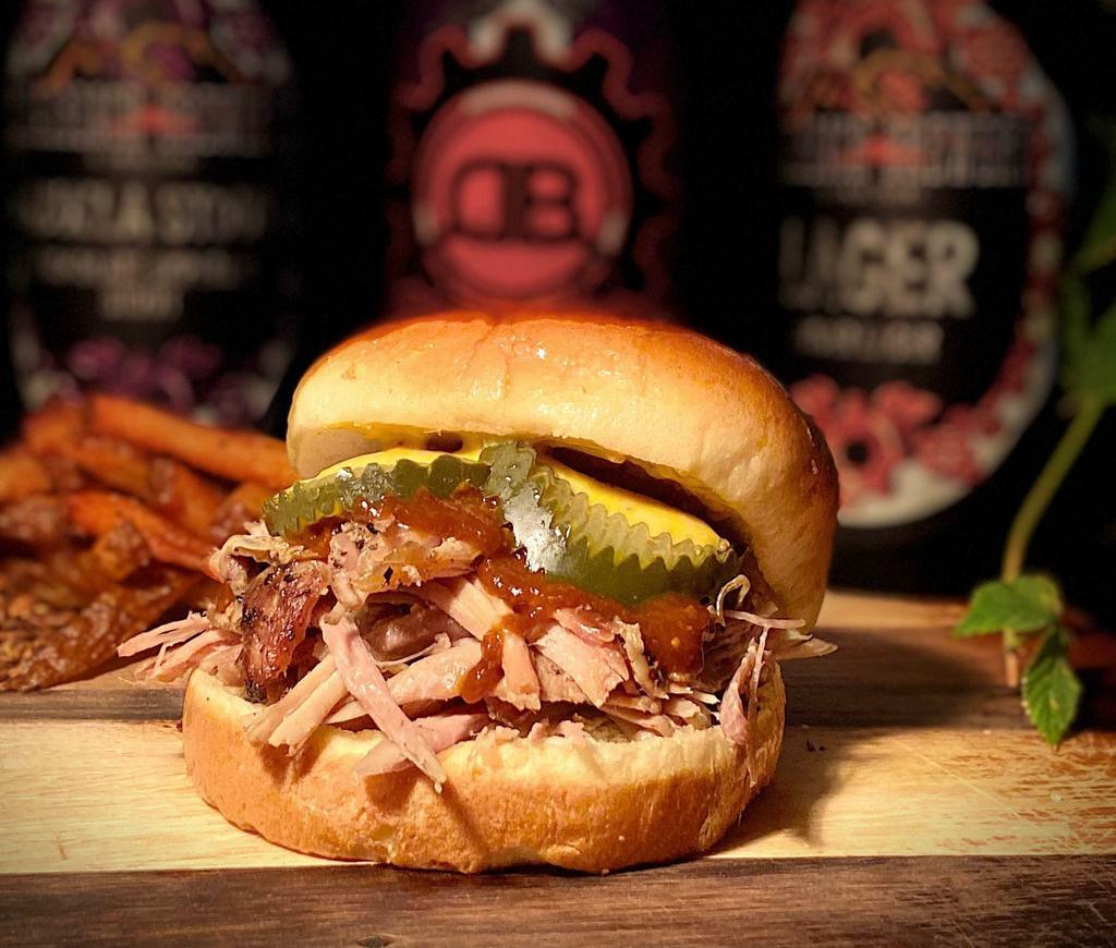 Porky and Bess Sandwich · Smokey pulled pork on a brioche bun, doused with our chipotle stout BBQ sauce, finished with our hefeweizen beer mustard and house dill pickle chips.