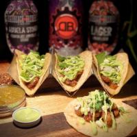 Johnny Cashed Taco · 4 crispy smoked brisket ends tacos with house made salsa verde onions cilantro and avocado s...
