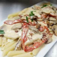 Chicken Valdostano · Roasted pepper, mushrooms and prosciutto in a brandy cream sauce with fresh mozzarella.