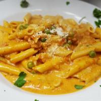 Penne alla Vodka · Tasty pink sauce with green peas.