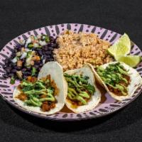 Al Pastor Tacos · Al pastor marinated soy sauteed with onions and pineapple served on 3 corn tortillas. Topped...