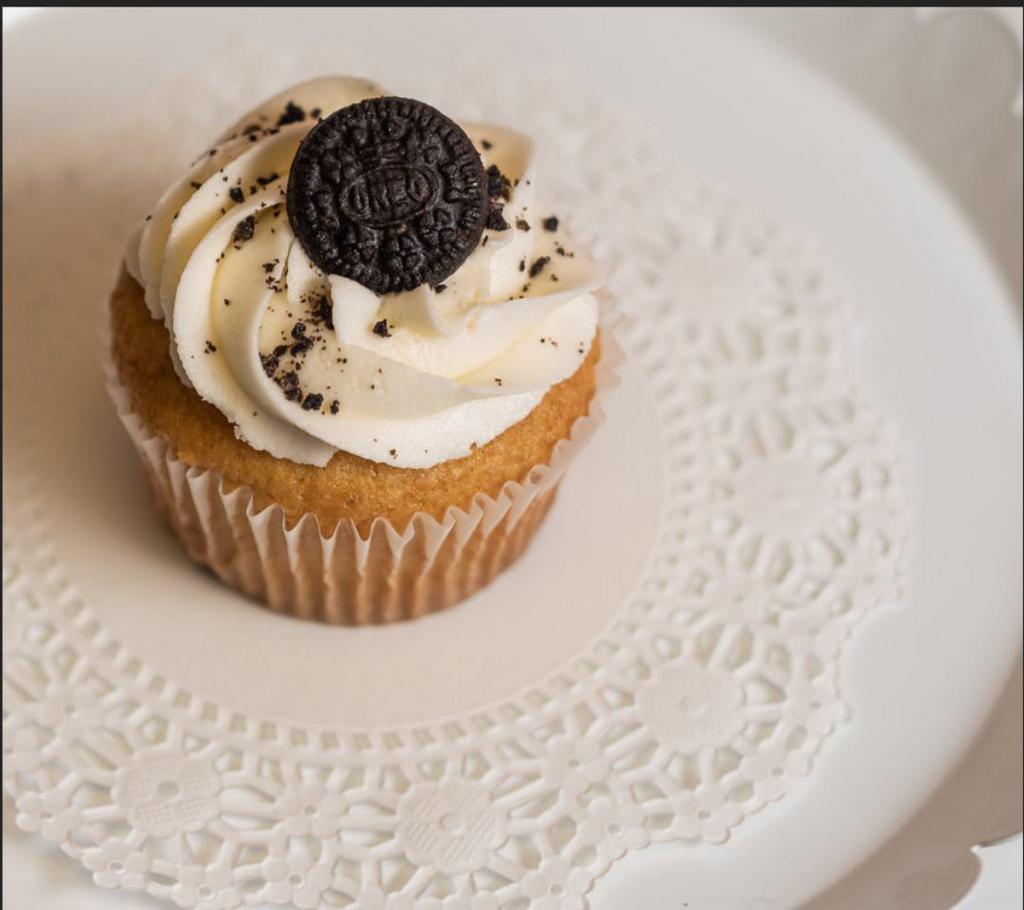 Oreo Cupcake · Soft vanilla cake with oreo cookies baked into the batter, topped with buttercream frosting and an oreo cookie.