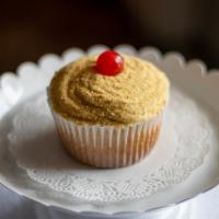 Cheesecake · Cheesecake flavored cake topped with buttercream, Graham crackers crumbs and a Maraschino ch...