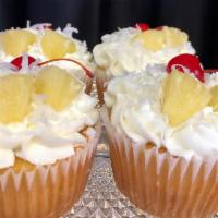 Pina colada  · Moist pineapple cake topped with buttercream icing, sweet coconut, fresh pineapple and a mar...