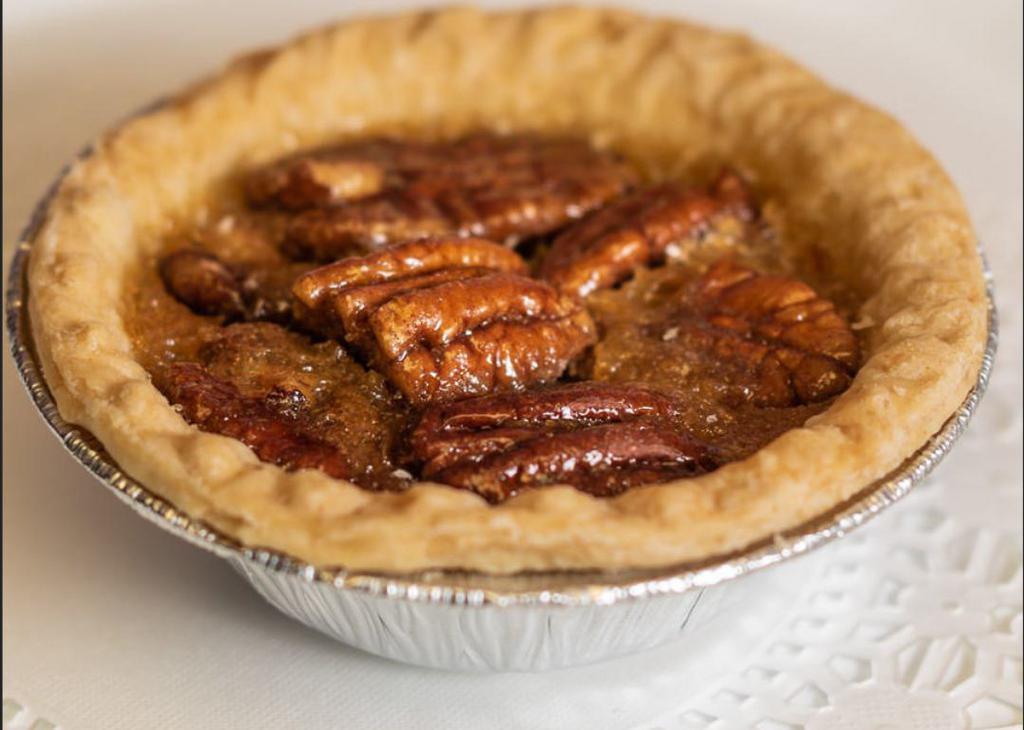 Mini Pecan Pie · Our southern-inspired pecan pie. Handmade in our bakery, it boasts a rich filling loaded with pecans, baked in a crisp and buttery pie shell.