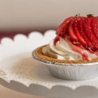 Mini Cheesecake · This creamy cheesecake with a graham cracker crust is topped with glazed strawberries.