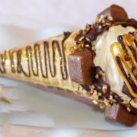 Snickers Delight  · Waffle cone dipped in chocolate covered with mini snickers and pecans, filled with snickers ...