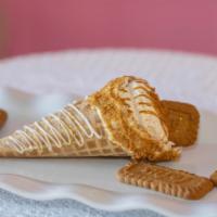 Biscoff cookie butter  · Waffle cone dipped in chocolate stuffed with cheesecake with biscoff cookie pieces topped wi...