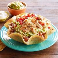 Baja Taco Salad · Baked tortilla shell, beans, lettuce, meat, cheese, sour cream, guacamole and pico de gallo.