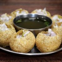 AP9. Pani Puri · Six puffed puri filled with potato, chickpeas, tamarind chutney and served with chilled spic...