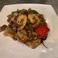 Pad Kee Mao · Spicy stir-fried flat noodles with egg, onions, tomatoes, string beans, bell peppers and bas...