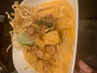 Khao Soi · Northern style curry noodle wt chicken, egg noodle, red onion, sprout, scallion,green pickle and crispy noodle. 