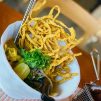 Kao Soi Noodles · Northern style curry noodle, slow-cooked chicken drumstick topped with crispy noodles scalli...