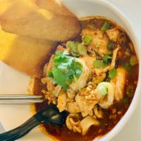 Tom Yum Noodle · Rice noodles with chicken, squid, shrimp, bean sprouts, green onions, and cilantro in tom yu...
