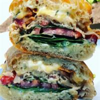 #5 - Turkey  · Oven roasted turkey, bacon, smoked gouda, spinach and tomato served with rosemary mayo on to...