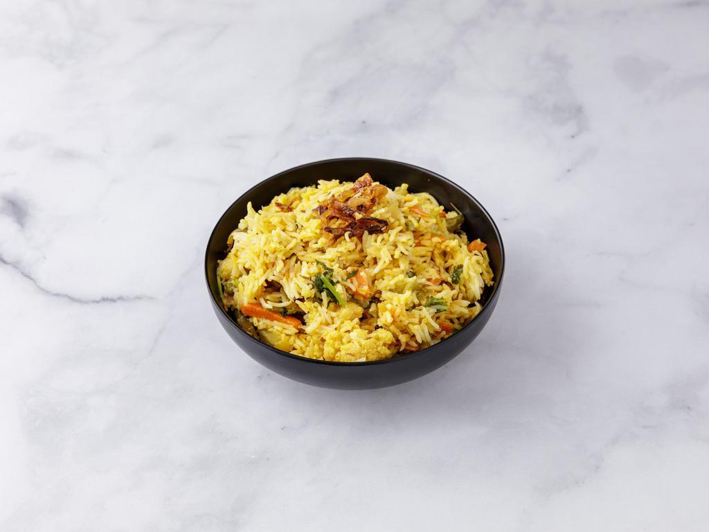 Vegetable Biryani · Basmati rice flavored with saffron and cooked with vegetables in a delicate blend of exotic spices and herbs.