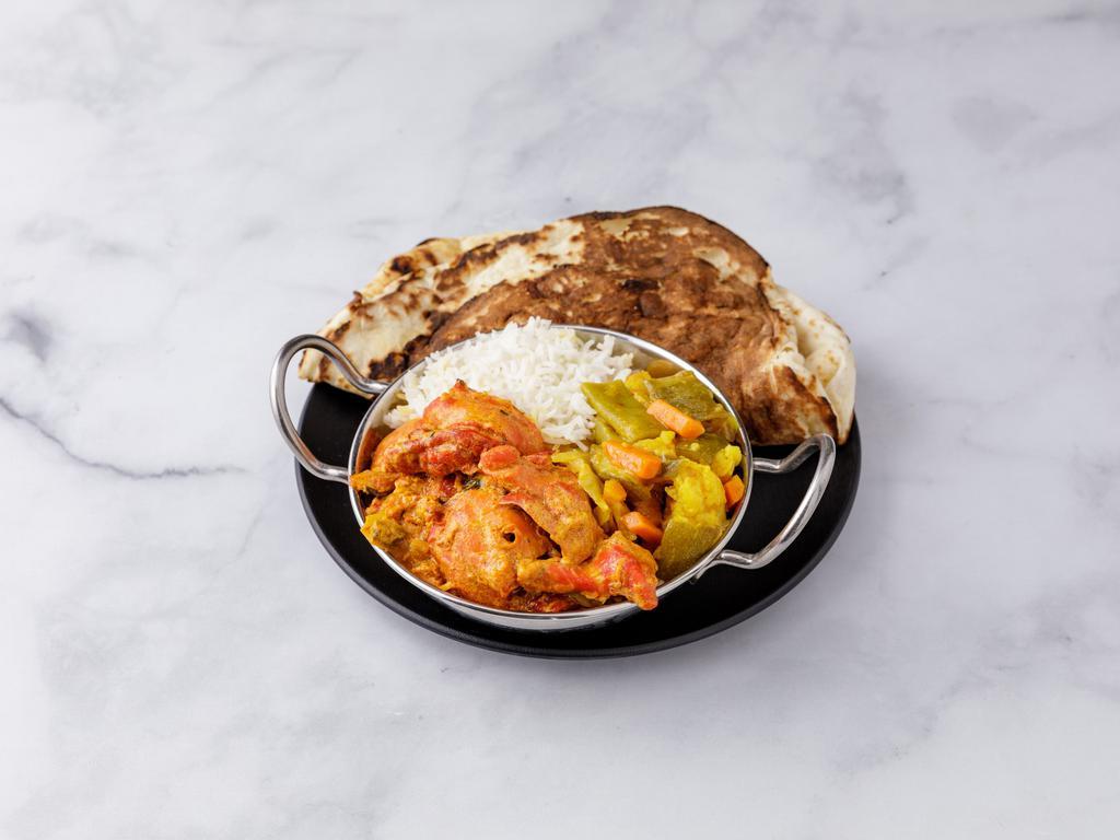 Combination Platter B · Includes chicken tikka masala, 1 vegetable curry, basmati rice, naan or paratha and green salad.