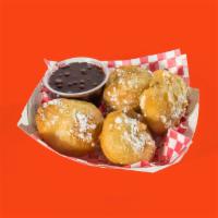 Fried Oreos · Every bit as amazing as it sounds. Oreo cookies hand-battered in our funnel cake batter and ...