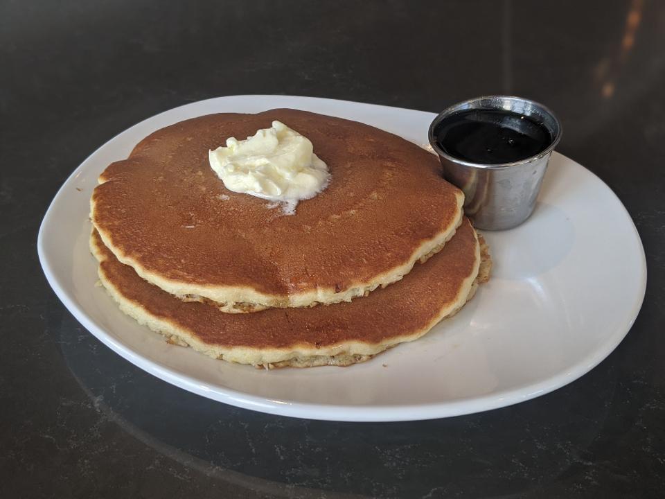 SHORT STACK BUTTERMILK · Two buttermilk pancakes, butter and syrup.