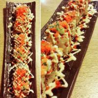 Centipede Roll · Spicy tuna, eel, avocado and crab topped with scallions and tobiko and deep-fried.