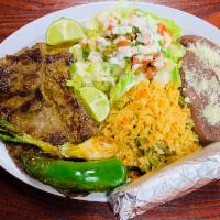 #2. Carne Asada · Grilled steak. Servido con arroz, frijoles, ensalada y una orden de tortillas. Served with r...