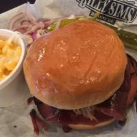 Smoked BBQ Sandwich · A quarter pound sandwich which Includes one side, pickle, pepper and onion.