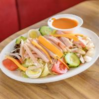 Chef Salad · Hefty portions of cold-cut ham and turkey served over romaine and iceberg lettuce, topped wi...