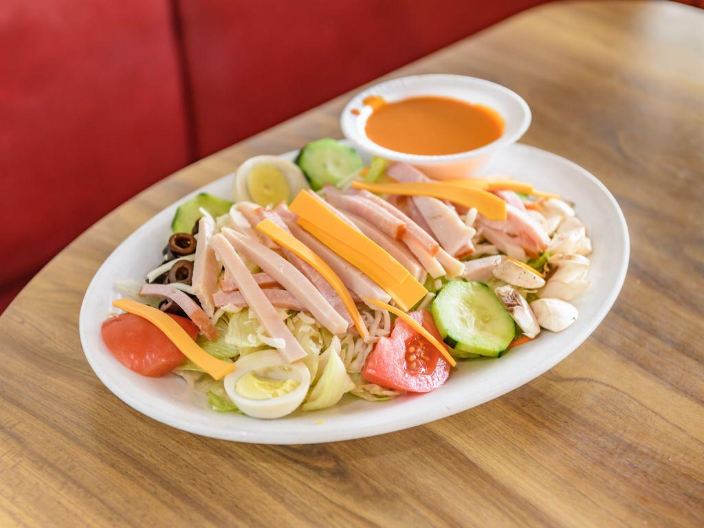 Chef Salad · Hefty portions of cold-cut ham and turkey served over romaine and iceberg lettuce, topped with a hard-boiled egg, shredded mozzarella and Monterey Jack cheese, house veggies and your choice of dressing.