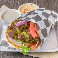 Falafel Pita   · Served on a pita with lettuce, tomatoes, onions, and choice of sauce.