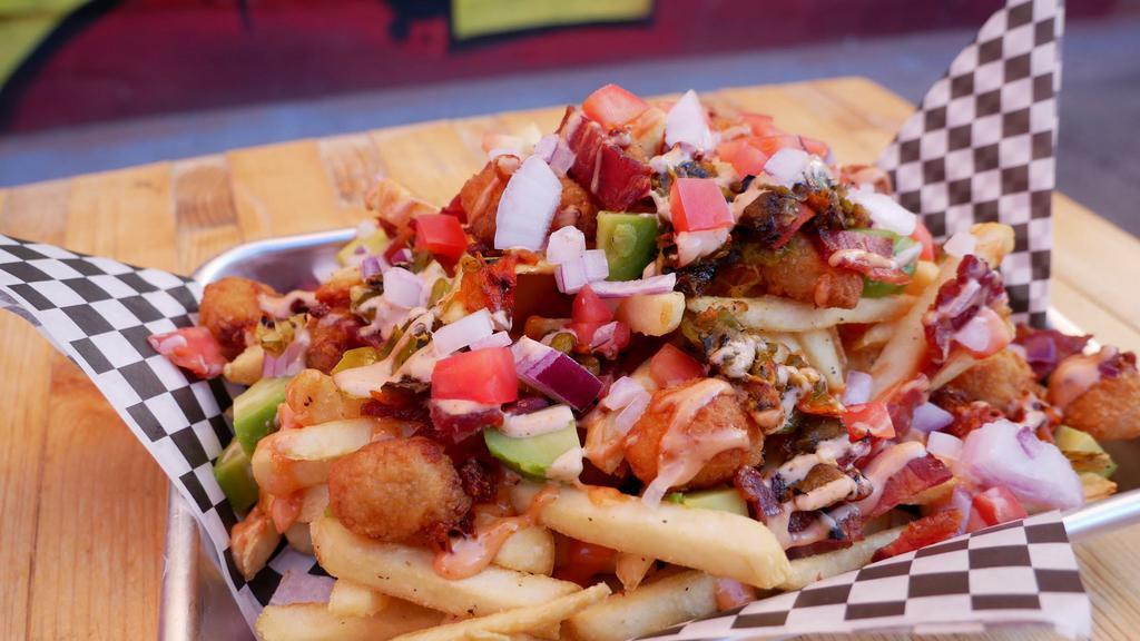 Dirty Fries · A big pile of crispy fries loaded with avocado, bacon, special sauce, NM green chile, red onions, and diced tomatoes.