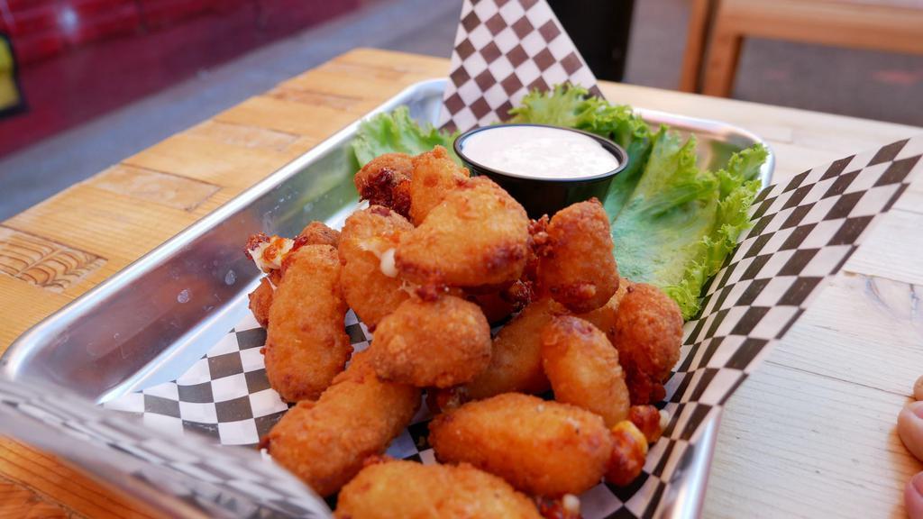 Cheese Curds · Crispy breaded Wisconsin white cheddar curds served with housemade ranch dressing. Make it 
