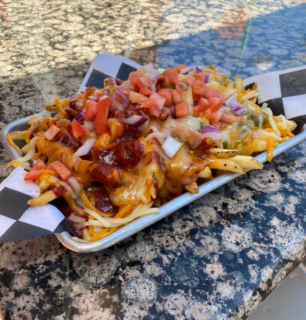 Chile Cheese Fries · Housemade NM green or red chile sauce and cheddar cheese. Topped with red onion and diced tomato.